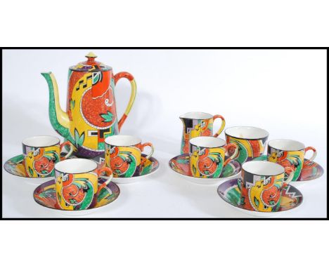 A retro vintage chine tea service with a coloured geometric shape pattern, to include six cups and saucers, a sugar bowl and 