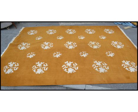 A very large 20th Century floor rug in the Chinese style, the rug on a light green ground with Chinese style characters decor