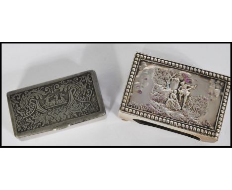 A silver hallmarked Victorian matchbox holder, the top in relief depicting a courting couple, raised on bun feet, Birmingham 