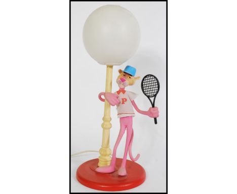 A vintage retro 20th century Pink Panther lamp featuring the iconic character in tennis attire stood next to a lamppost.&nbsp