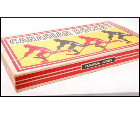 A vintage Munro made Canadian Hockey tin plate table&nbsp;top&nbsp;ice hockey game within the original box. Appears complete 