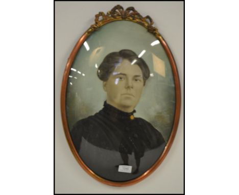 A Victorian oval convex glass watercolour portrait study of a lady in period dress set in gilt frame with ribbon crest mount.