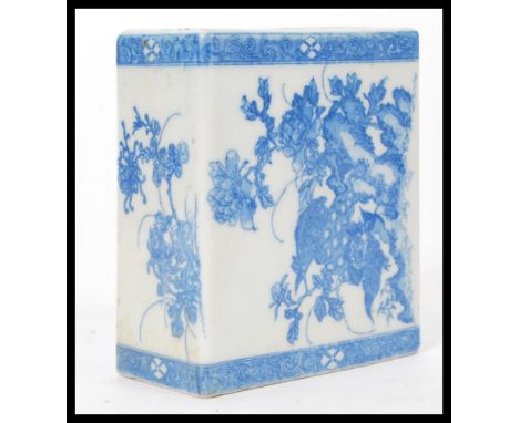 A 19th century Chinese blue and white ceramic square pillow vase hand painted with flowers and mythical beasts. Measures 15cm