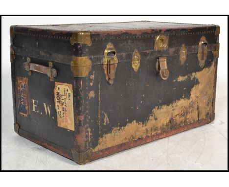 A good early 20th century blue brass bound steamer trunk chest with clasp handles, brass bindings and edgings with remains of