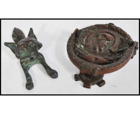 A Dutch bronze door knocker with latin notation together with an English bronze door knocker in the form of a fox. Biggest me