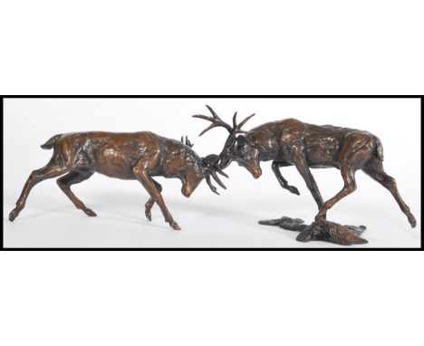A bronze figuring of two rutting stags on an incorporated base by Michael Simpson, baring the artists stamp MS to the base, n