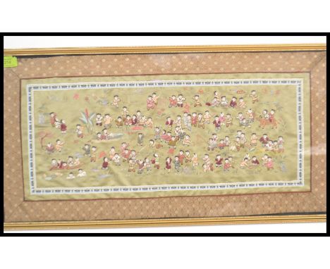 A 20th century Chinese silk hand embroidered tapestry depicting the 100 children being framed and glazed.