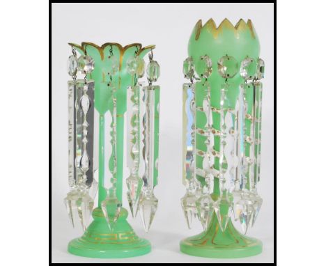 A pair of 19th century Victorian green glass lustres with with crenelated rims, having ten prismatic faceted cut glass crysta