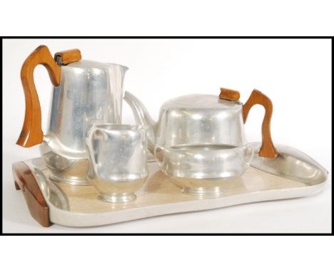 A 20th century Picquot Ware tea service to include tea and coffee pot with wooden handles, a twin handled sugar bowl and milk