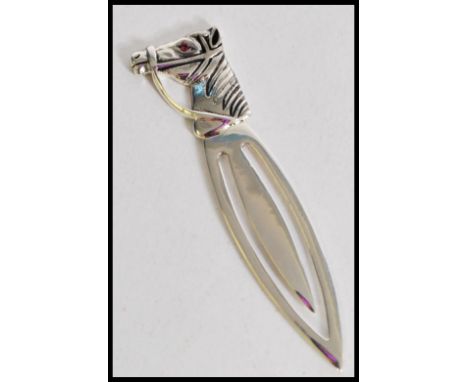 A silver bookmark with a horse head finial, having a ruby to the eye. Weight 3.6g. Measures 6cm.