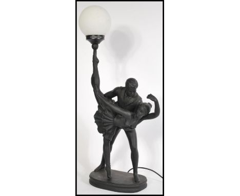 A vintage 20th century Art Deco style large table lamp in the form of an entwined dancing couple with milk glass globular sha