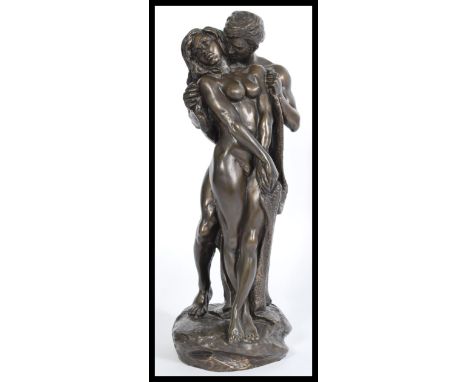 A bronzed sculptural figure group modelled as an entwined naked couple embraces in a loving position raised on a pedestal bas