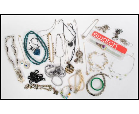 A collection of vintage costumer jewellery to include necklaces, bracelets, jade bangle, boxed Swatch Watch etc.