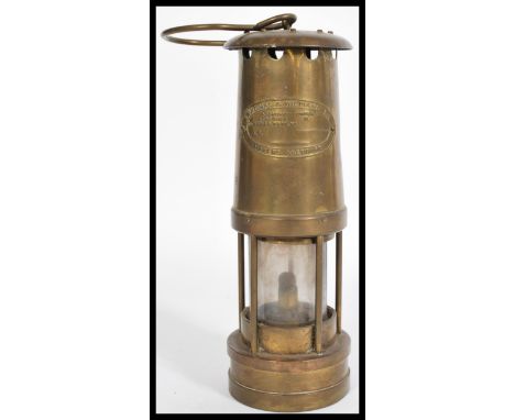 E. Thomas &amp; Williams Ltd copper and brass miners lamp with carry loop to the top.&nbsp;Measures 24cm-high 8.5cm-diameter.