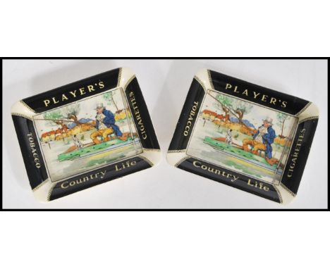 A pair of unusual early 20th century ceramic cigarette advertising ashtrays for Player's Country Life Tobacco. Each with pict