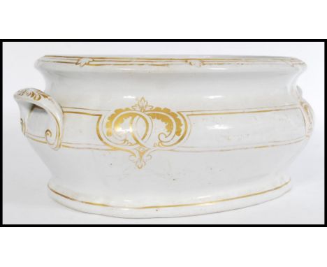 A 19th century Victorian large ceramic foot bath having shaped handles and gilded decoration. Measures 21 cm high x 48 cm wid