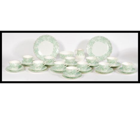 An early 20th Century bone extensive bone China transfer printed tea service to include trio, creamer, slop's bowl etc. Measu