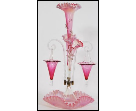 A 19th century Victorian glass epergne centre piece, having a central trumpet with a frilled rim above two similar smaller tr