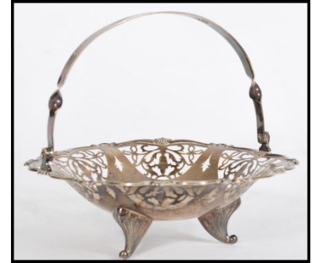 A large continental silver bon bon dish basket having arched pierced handle over lattice worked bowl on tazza step. Stamped S