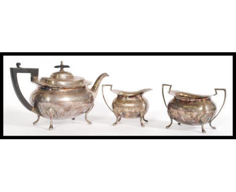 An early 20th century Walker and Hall silver plated tea set with pad feet and shell form shoulders to include a teapot with s