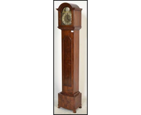 A good quality walnut cased tempus fugit grandmother clock. The walnut trunk and hood with inset brass and silvered face havi