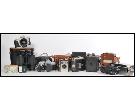 A collection of vintage cameras to include a Kodak Brownie Flash III, Praktica MTL3, a cine Kodak eight 55 film camera, a Can