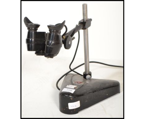 A vintage mid century opticians eye glass magnifier lamp by Cooke &amp; Yorke. Ebonised with weighted base having eye scopes 