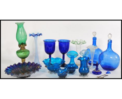 A collection of 19th century Victorian green and blue glass wares to include a green glass and brass oil lamp, 2 x blue glass
