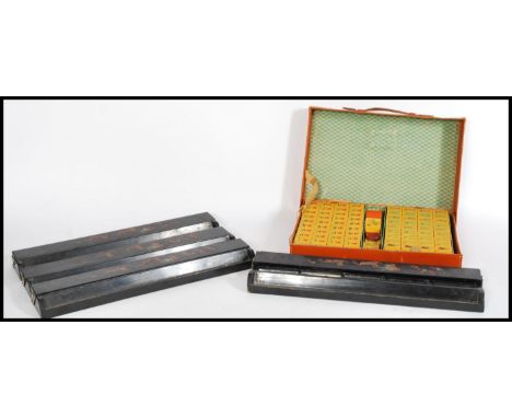 A 20th century Chinese Mahjong set having bakelite / lucite playing pieces and a set of four ebonised stands with dragon deco