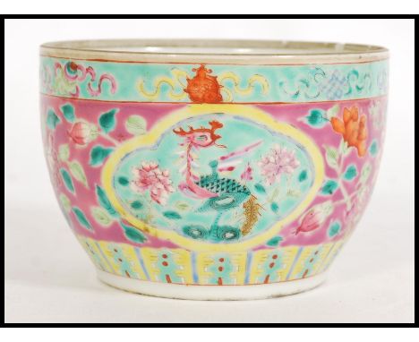 A 19th century Nyonya Chinese ceramic pot having hand enameled decoration on a famille rose ground with green cartouche panel