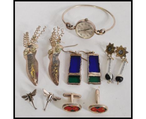 A collection of stylish designer silver - white metal costume jewellery to include stained glass drop earrings, dragonfly ear