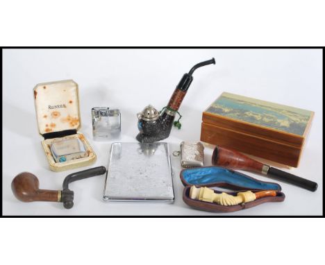 A selection of vintage 20th century smoking related items to include a&nbsp;Meerschaum carved bone pipe depicting holding han