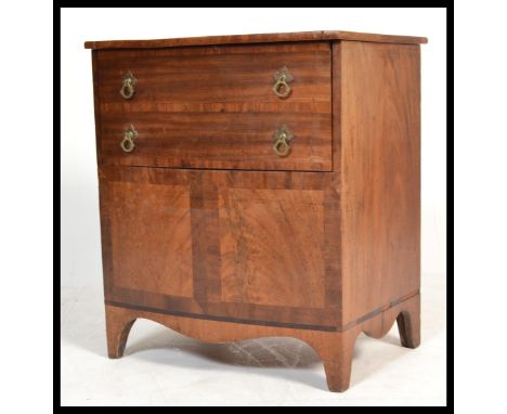 A 19th century mahogany bow front commode chest having French kick legs supporting bow front body with hinged top and faux dr