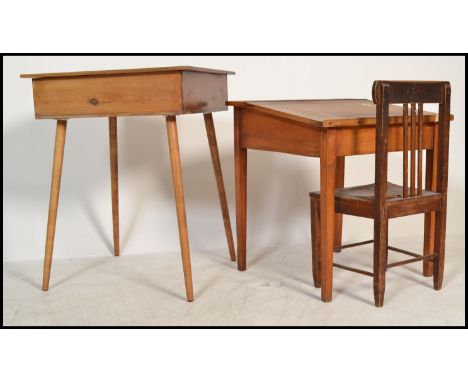A pair of mid century Industrial / school desks in light beech wood construction, both having hinged tops together with a sch