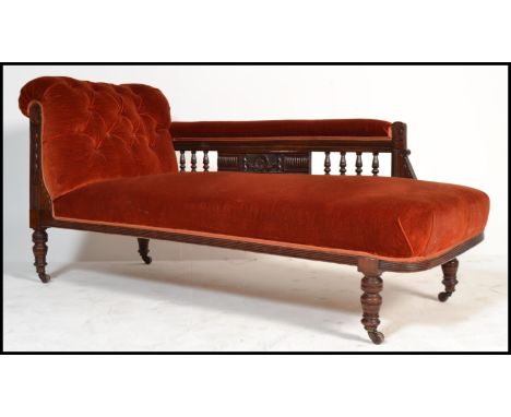 An early 20th Century Edwardian chaise longue with upholstered button back seat, scrolled back and arm rest, carved detail an