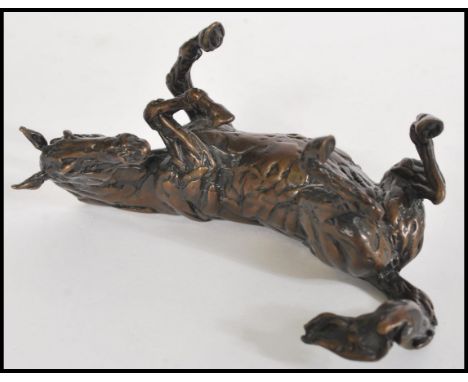 A bronze figurine of a horse reclining by Lucy Kinsella, signed to the base 'Kinsella' marked A/P L. Measures 9 cm high and 1