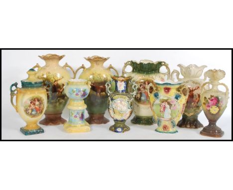 A selection of 19th century Staffordshire pairs of vases to include a pair featuring Clyde deer with scrolled gilt handles an