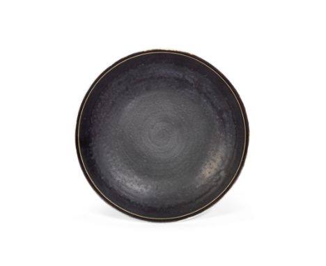 Lucie RieDish, late 1950sStoneware, manganese glaze with incised rim.18cm diameterUnderside with impressed LR seal.This lot i