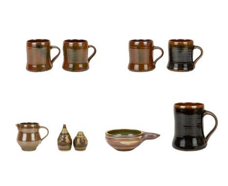 Crowan Pottery A collection of nine pieces  Including one pint mug, four half pint mugs, one milk jug, an egg poacher, one sa