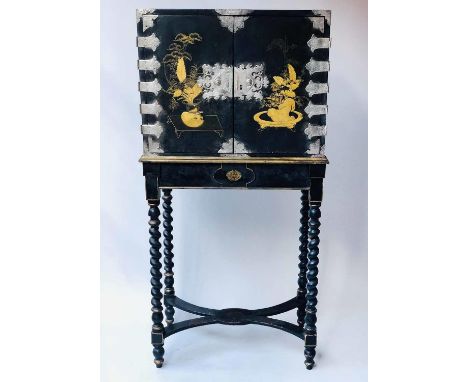 CABINET ON STAND, 18th century Chinese export decorated gilt and black lacquer with two doors enclosing drawers on a later co