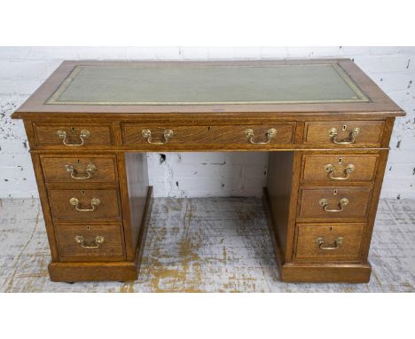 PEDESTAL DESK, late Victorian oak with green leather top above nine drawers on castors, 73cm H x 123cm W x 59cm D. 
