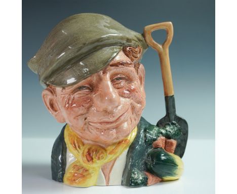 This charming ceramic jug portrays a cheerful gardener with a weathered, friendly face. He wears a gray hat, a textured green