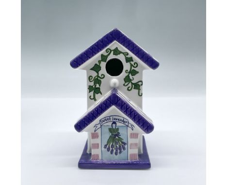 A part of the Home Sweet Home Royal Doulton collection, this whimsical white and purple porcelain birdhouse features painted 