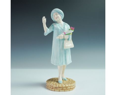 Crafted from fine bone china, the figure depicts the Queen Mother in a light blue coat dress with a matching hat, pearl neckl