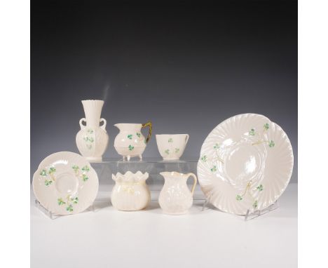 This collection includes a plate, a cup with a matching saucer, two creamers, and a vase. Each piece is crafted in Belleek's 