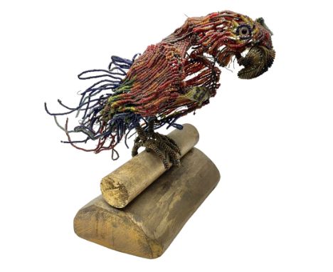 Victorian bead and wire model of a parrot, of polychrome beads, with glass eyes, on a wooden base, H24cm
