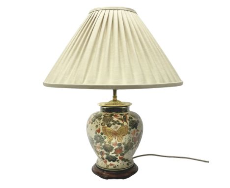 Japanese ceramic table lamp, decorated with flowers and butterflies upon a circular wooden base, with shades H52cm