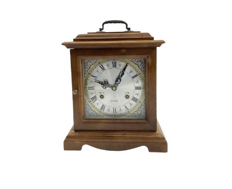 20th century - month going mantle clock, in a pine case with carrying handle on a decorative plinth, square silvered dial wit