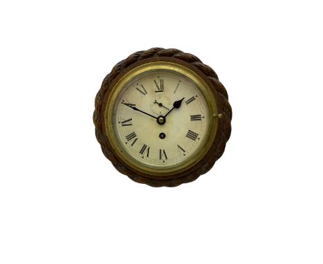Edwardian - 8-day ships bulkhead clock and an Aneroid barometer.In matching circular oak cases with carved rope twist bezels.