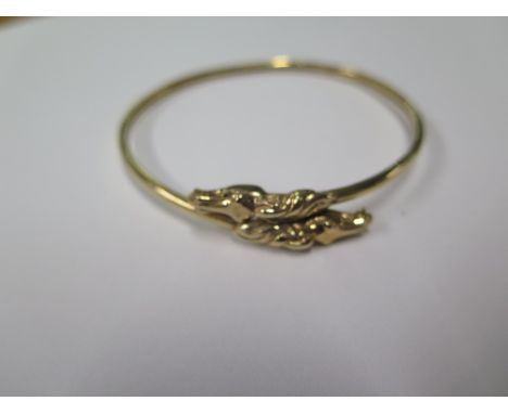 A hallmarked 9ct gold horses head bangle, 6.5cm x 6.5cm, approx 9.7 grams, small split and some minor bending otherwise gener